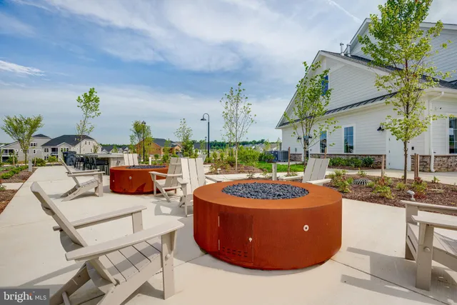 a view of an house with backyard and seating area
