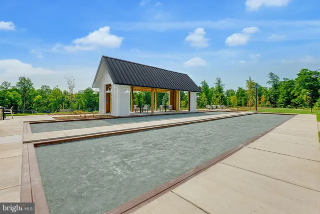 a view of a patio with a table and chairs and potted plants