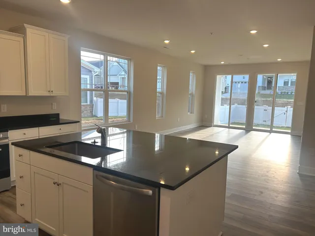 a kitchen with granite countertop a sink and a window
