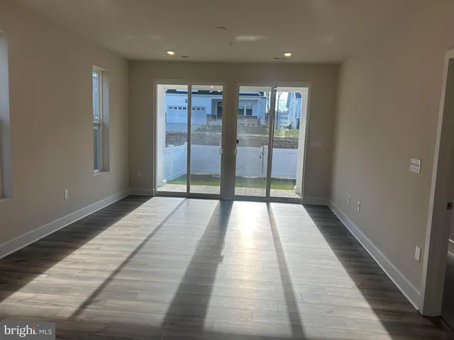 a view of hallway with wooden floor and glass door