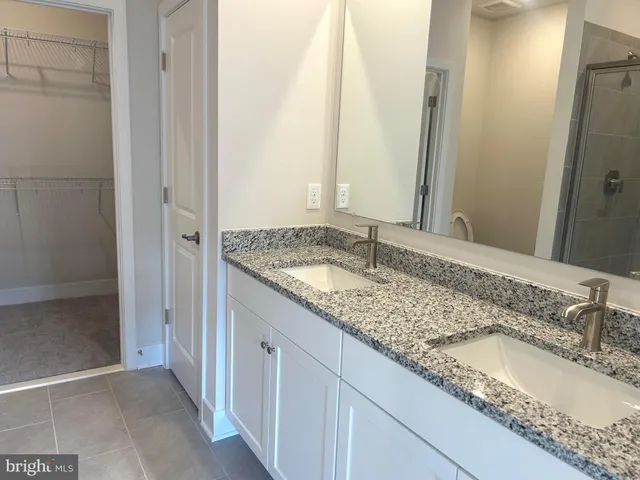 a large kitchen with granite countertop a sink and a stove