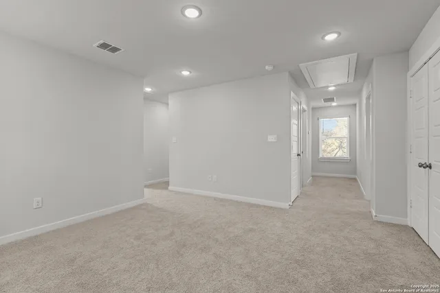 an empty room with entrance and mirror