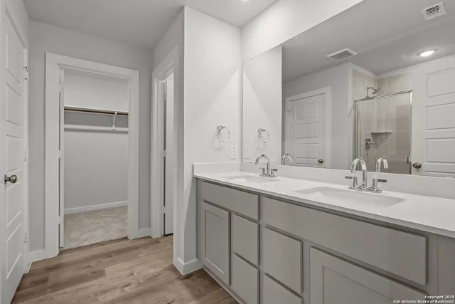 a bathroom with double sink and mirror