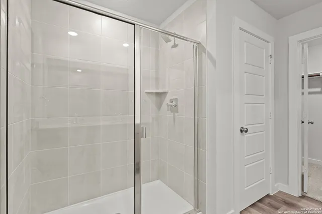 a bathroom with a glass shower door