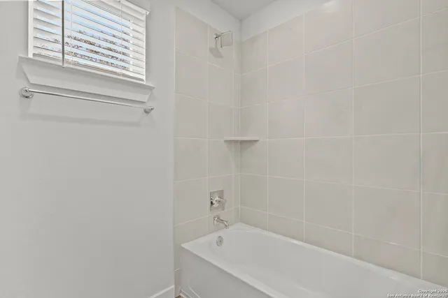 a white bath tub sitting next to a white sink