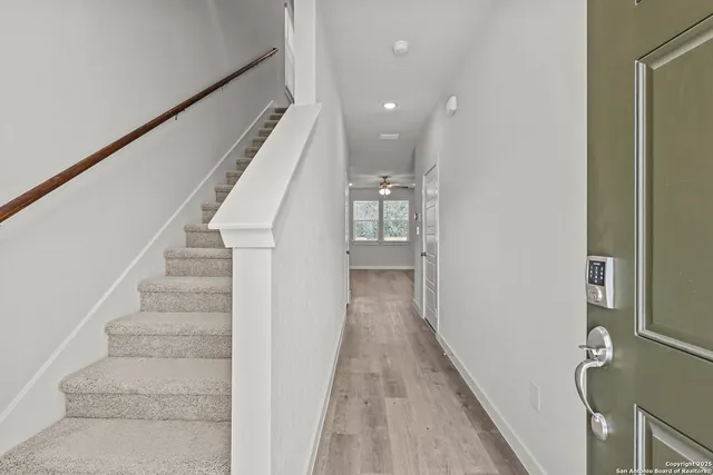 a view of entryway and hall with wooden floor