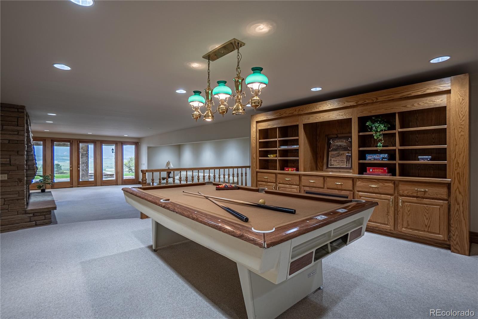 3282 Tomah Road Larkspur, CO 80118 - Photo 24 of 35 a living room with pool table and chandelier
