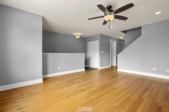 a view of an empty room with wooden floor
