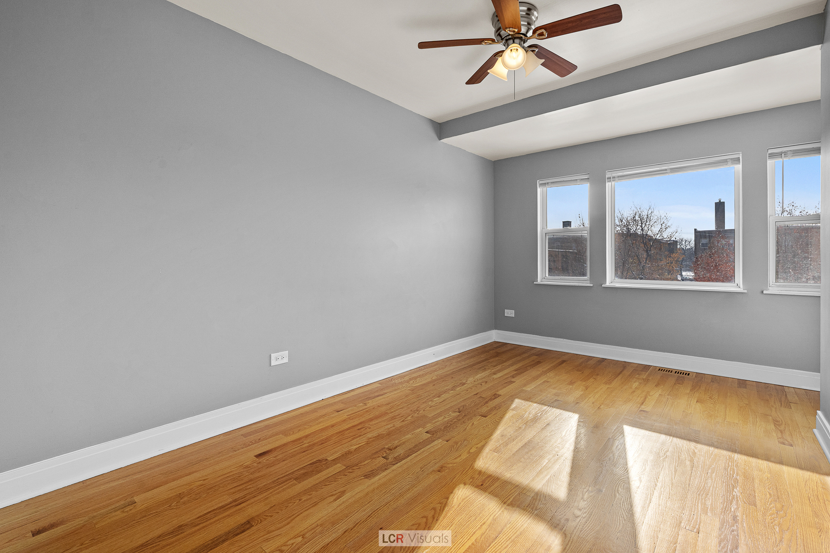 3422 West 13th Place Chicago, IL 60623 - Photo 9 of 15 a view of empty room with wooden floor and fan