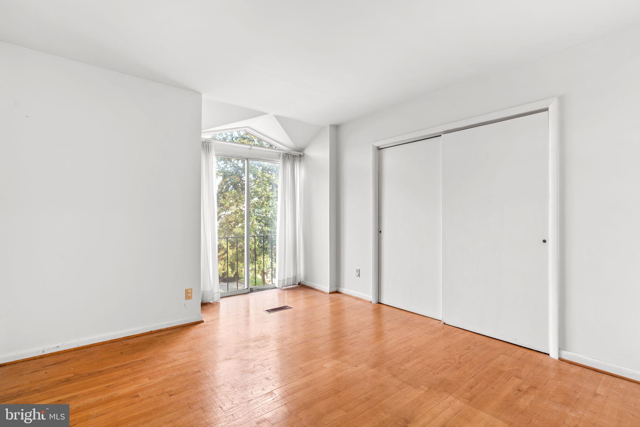 10390 May Wind Court Columbia, MD 21044 - Photo 15 of 29 an empty room with wooden floor and windows