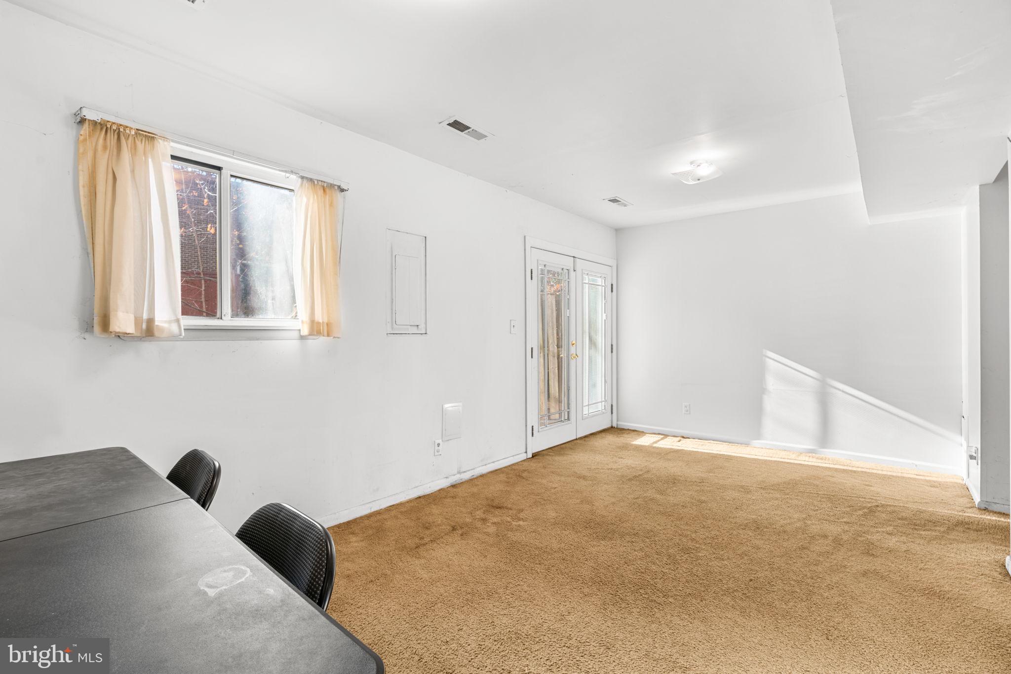 10390 May Wind Court Columbia, MD 21044 - Photo 7 of 29 a view of a big room with windows and chandelier fan