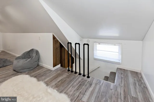 a view of wooden floor and windows in a room