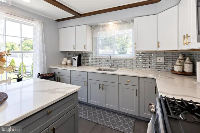 a kitchen with a sink stove and cabinets