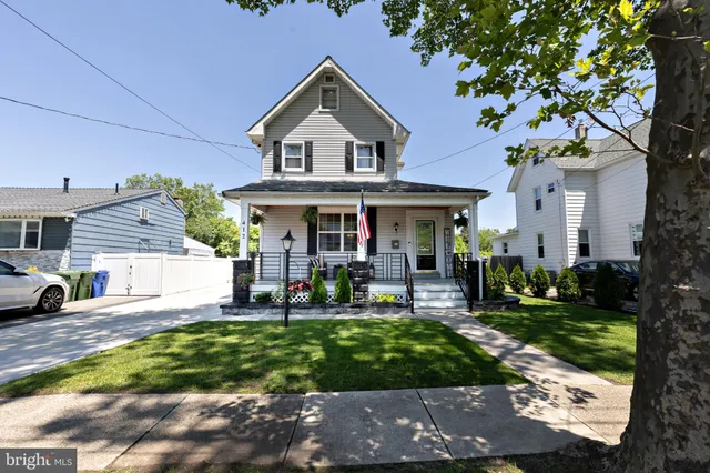 a front view of a house with garden and porch