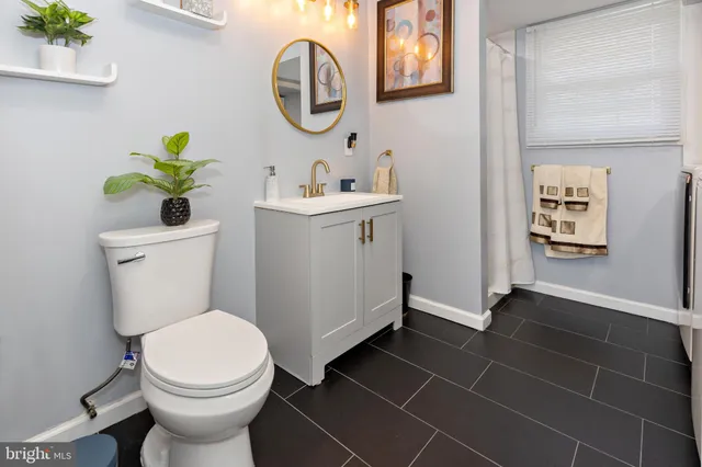 a bathroom with a toilet sink and mirror