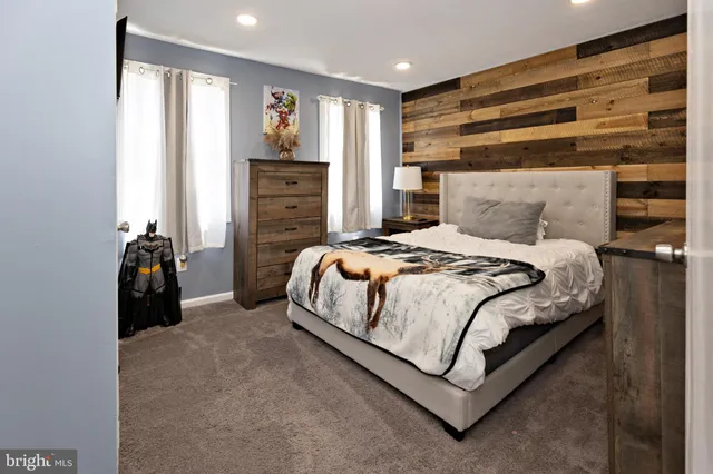 a bedroom with a bed a closet and large mirror