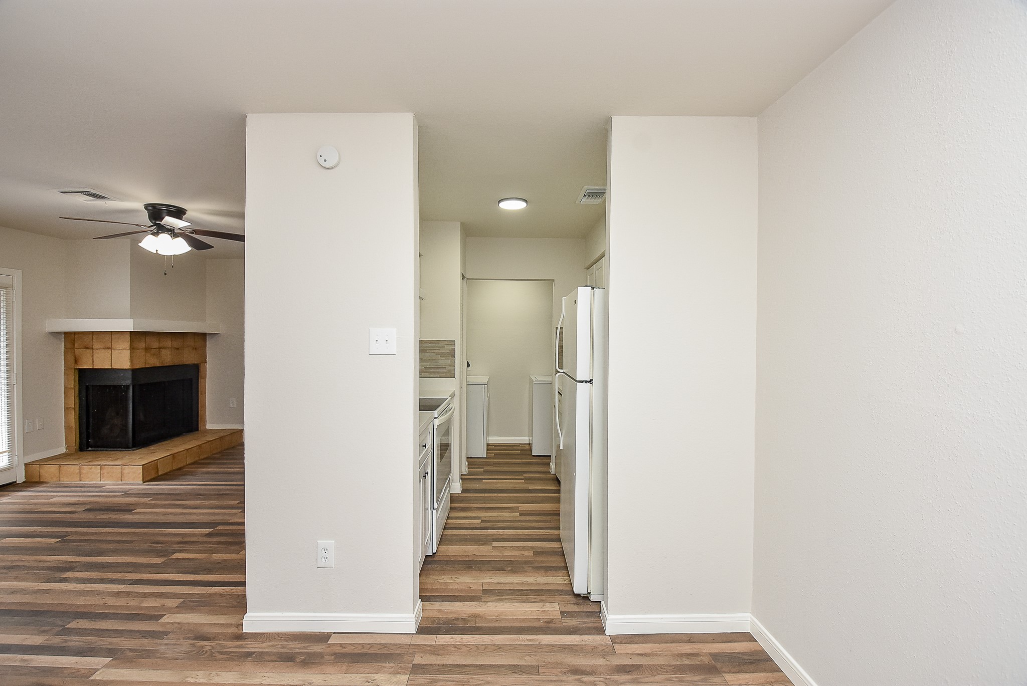 3644 Ocee Street Houston, TX 77063 - Photo 11 of 32 a view of a hallway with wooden floor and staircase