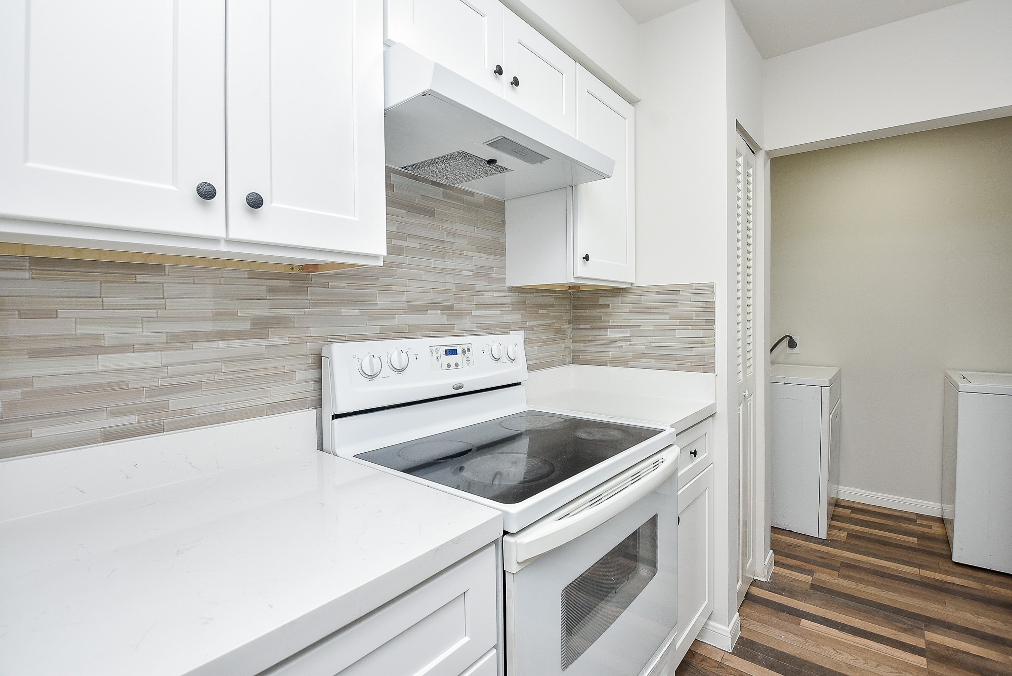 3644 Ocee Street Houston, TX 77063 - Photo 13 of 32 a kitchen with granite countertop white cabinets and white appliances