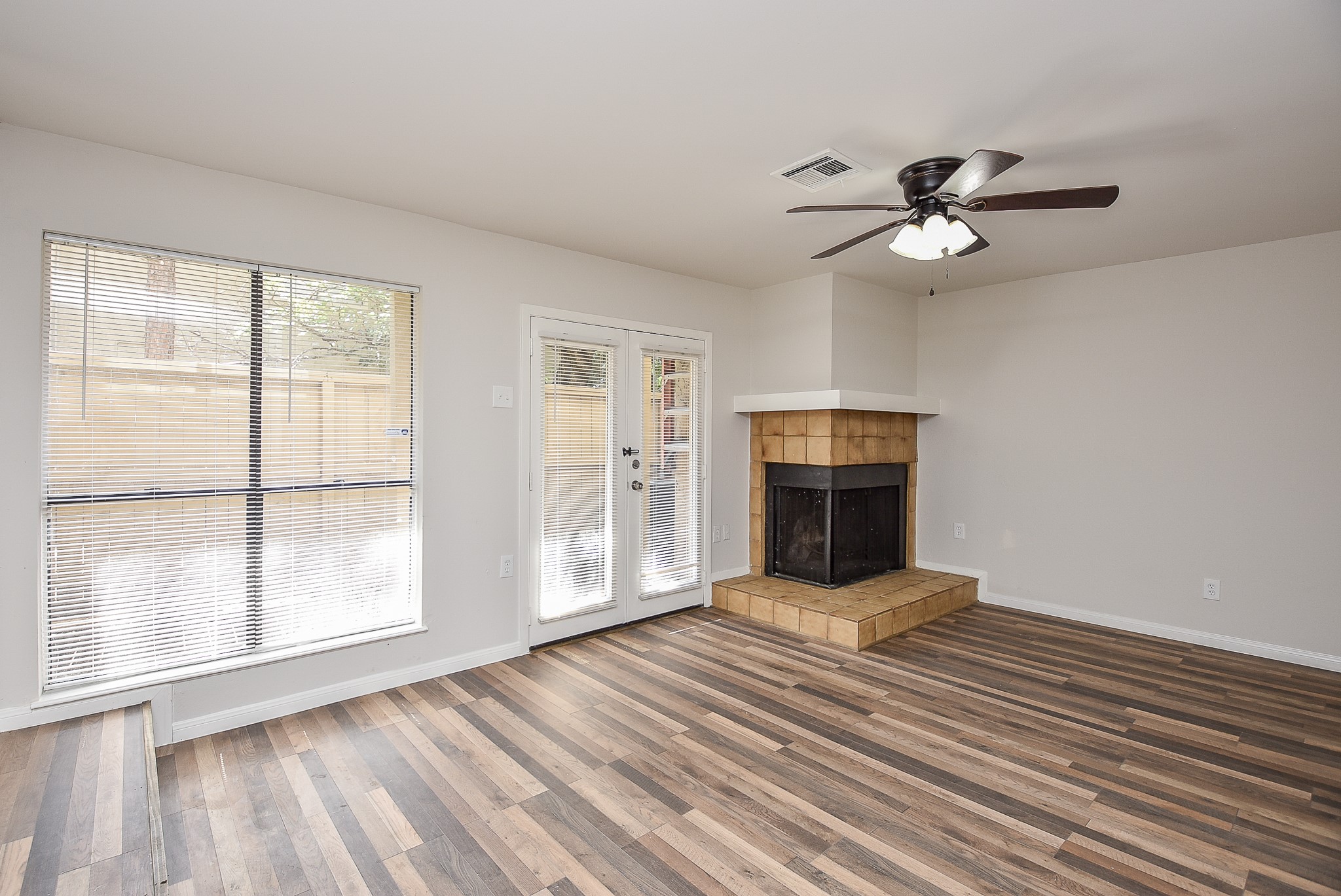 3644 Ocee Street Houston, TX 77063 - Photo 2 of 32 a view of an empty room with a window and wooden floor