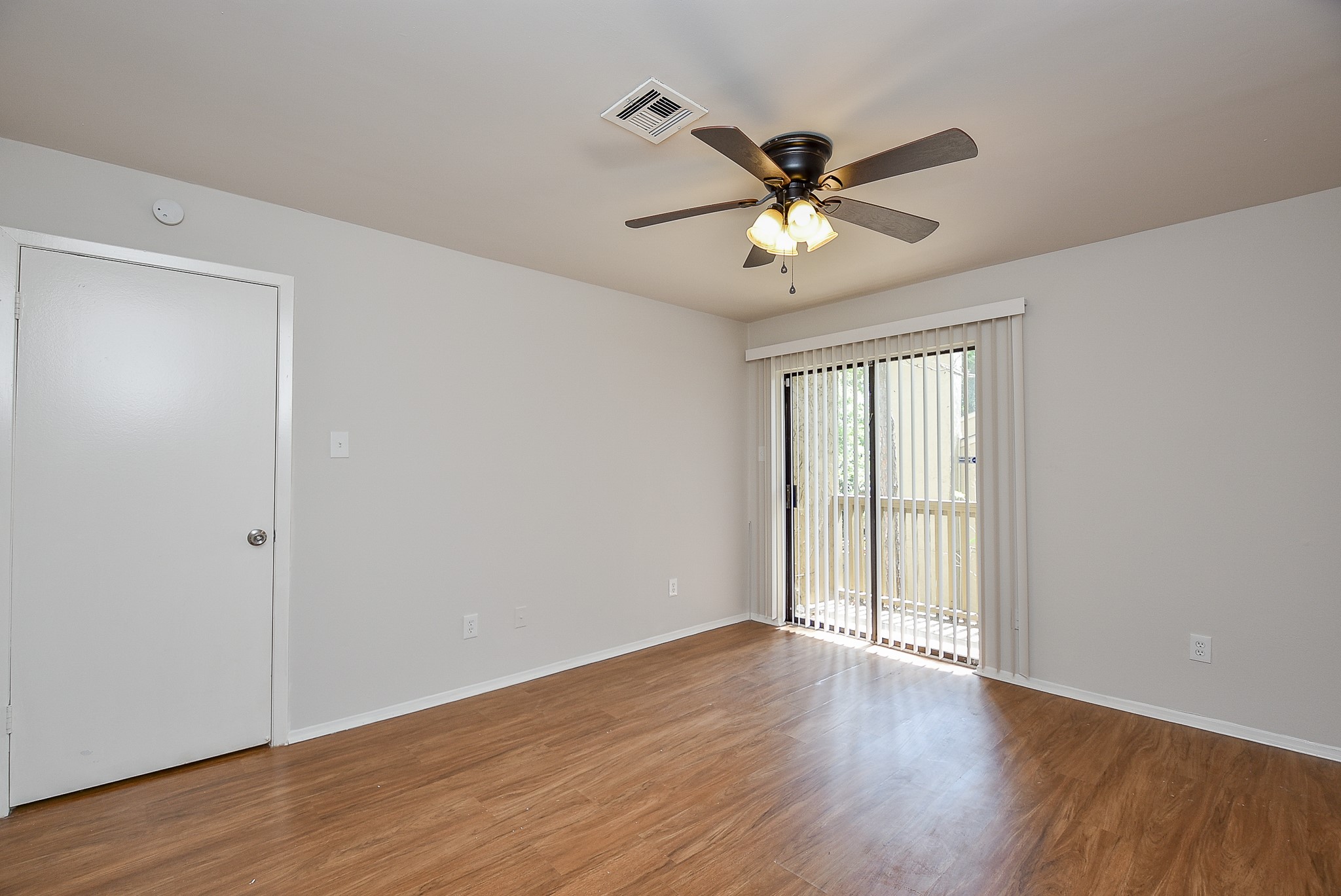 3644 Ocee Street Houston, TX 77063 - Photo 24 of 32 a view of an empty room with wooden floor and a ceiling fan