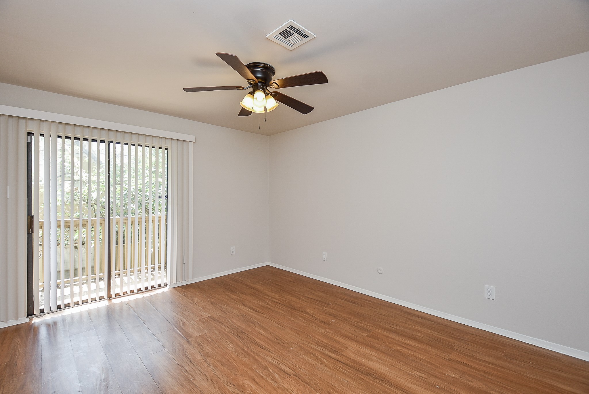 3644 Ocee Street Houston, TX 77063 - Photo 25 of 32 an empty room with wooden floor fan and windows