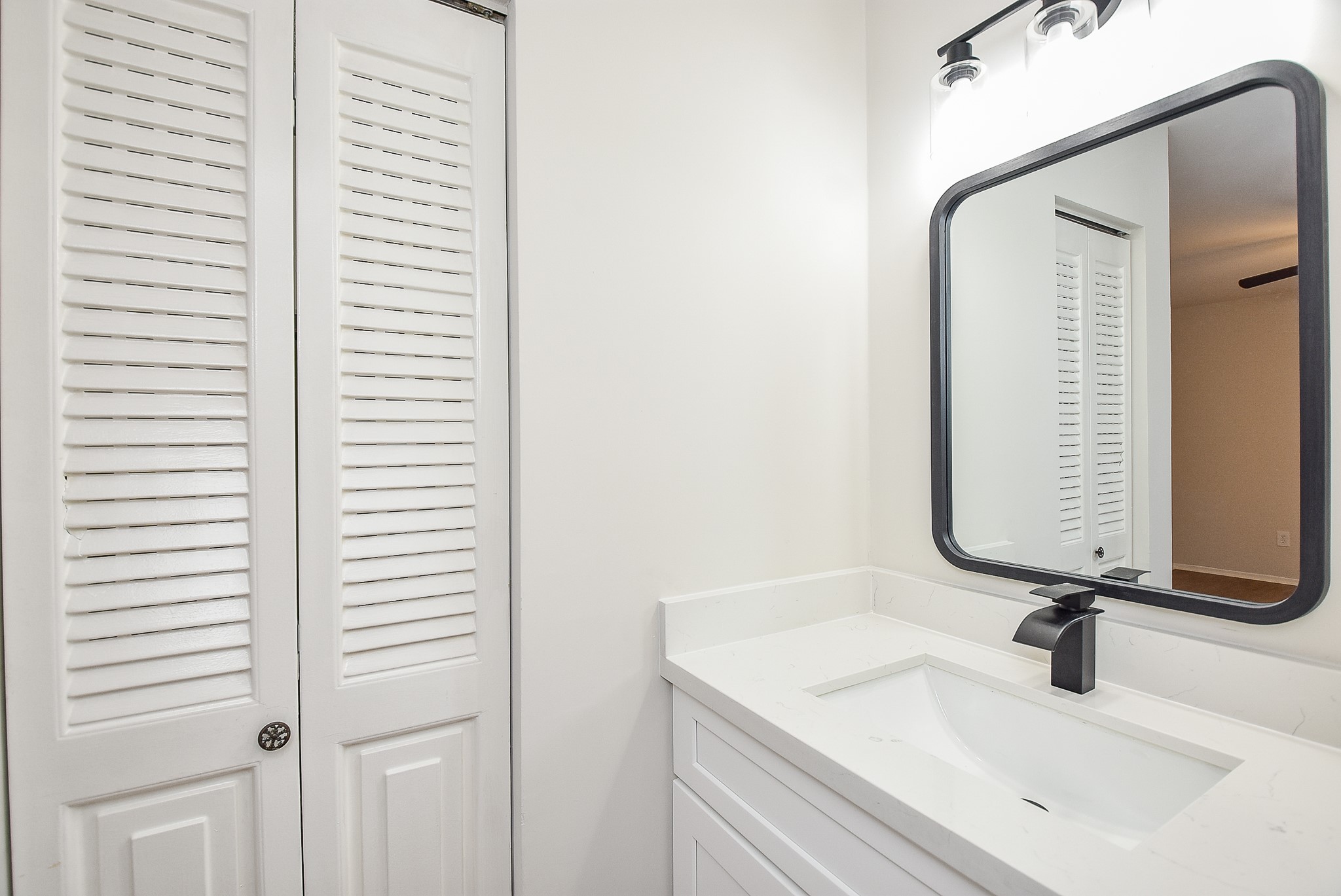 3644 Ocee Street Houston, TX 77063 - Photo 28 of 32 a bathroom with a sink and a mirror