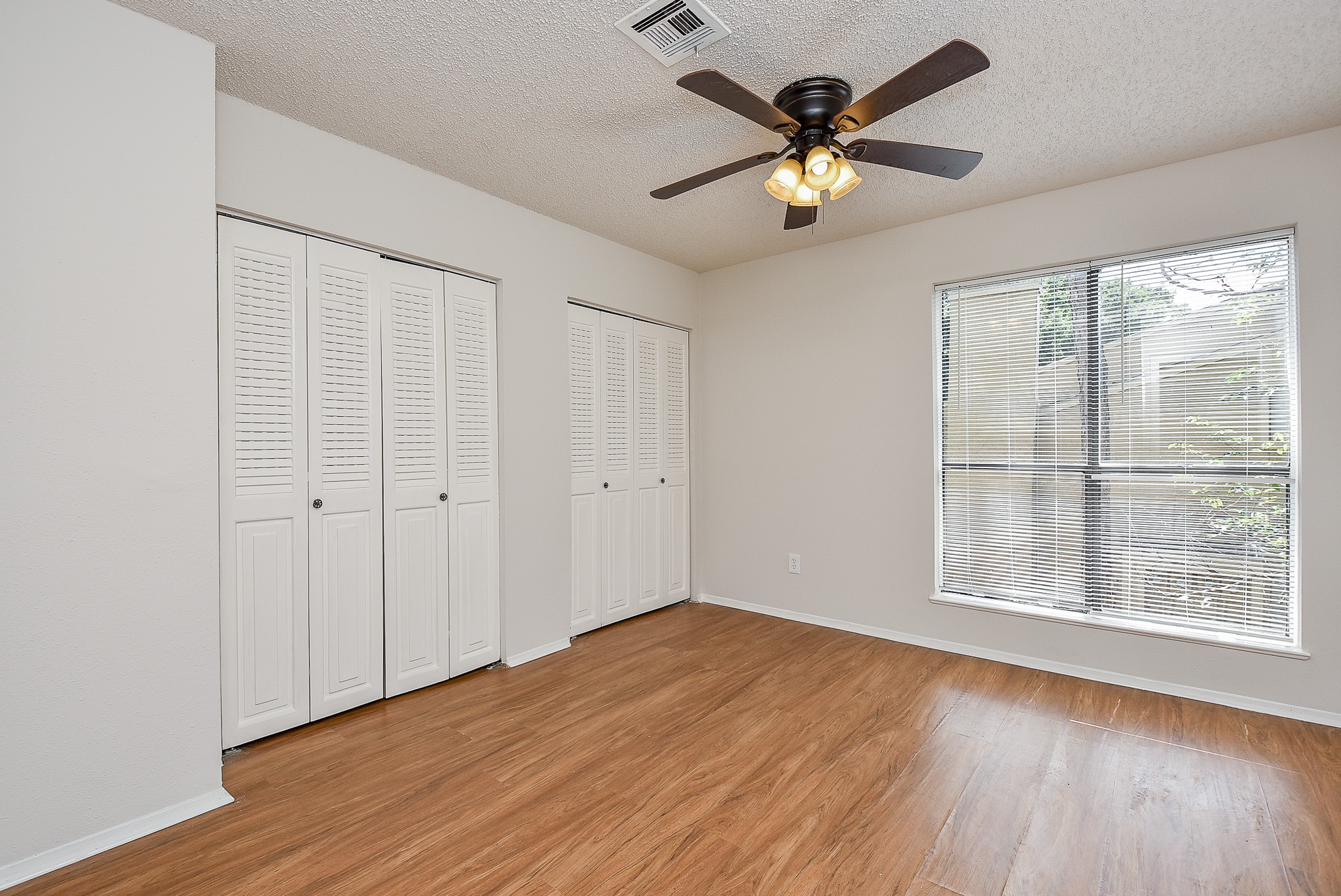 3644 Ocee Street Houston, TX 77063 - Photo 29 of 32 an empty room with wooden floor and windows