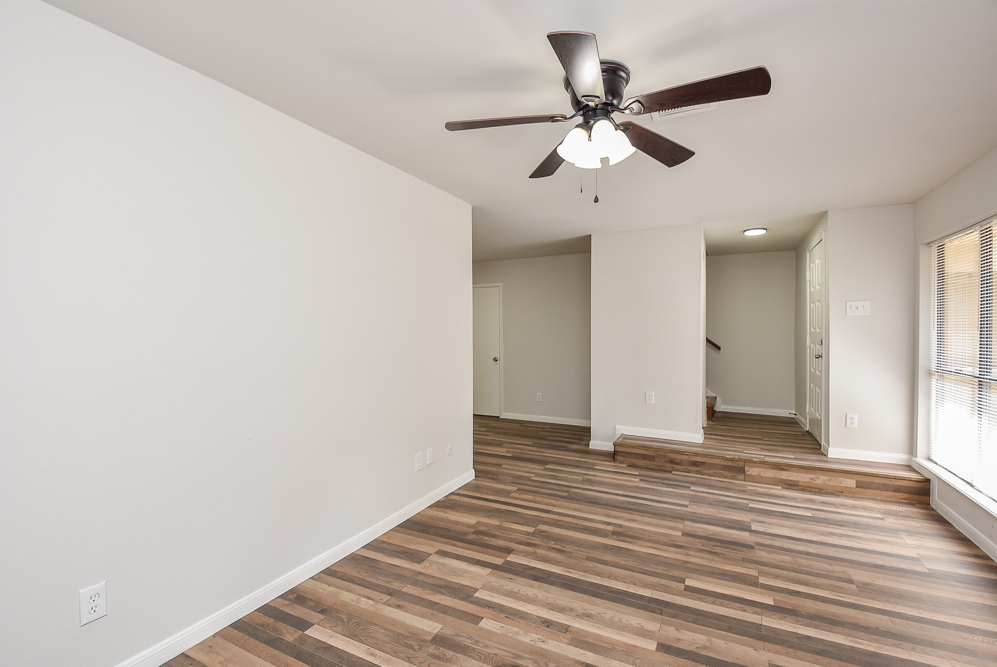 3644 Ocee Street Houston, TX 77063 - Photo 4 of 32 a view of an empty room with wooden floor and a ceiling fan