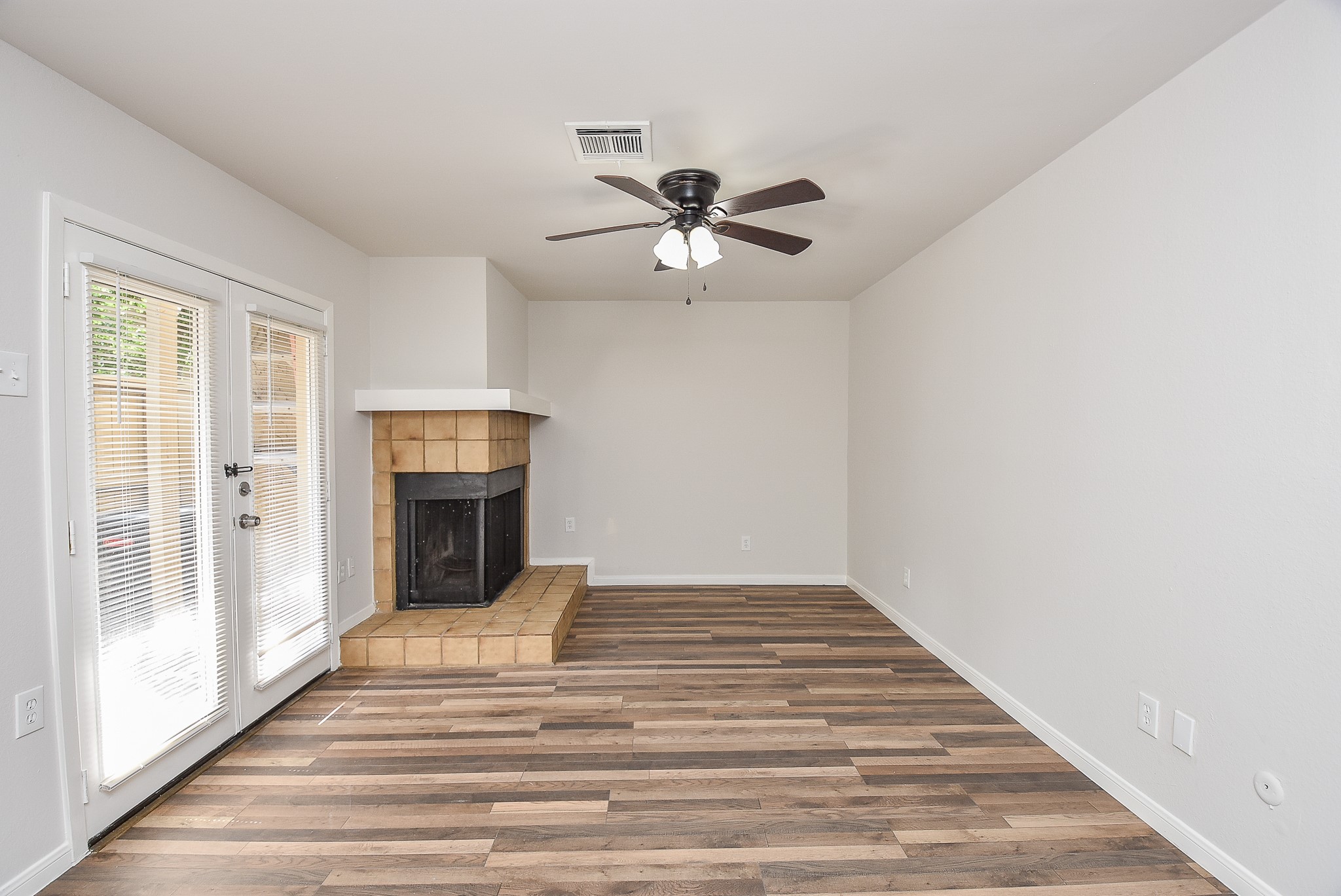 3644 Ocee Street Houston, TX 77063 - Photo 6 of 32 a view of an empty room with a fireplace and a window