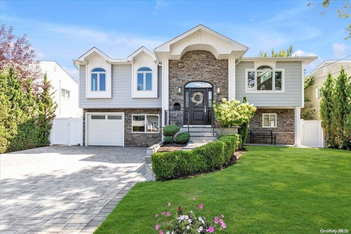 a front view of a house with a garden