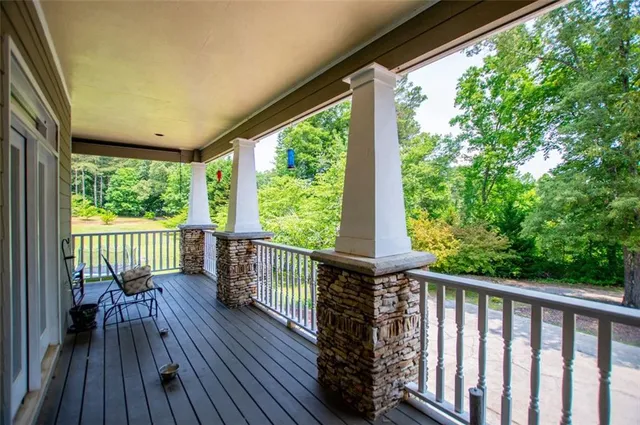 a kitchen with stainless steel appliances granite countertop wooden cabinets a sink and dishwasher a stove with wooden floor