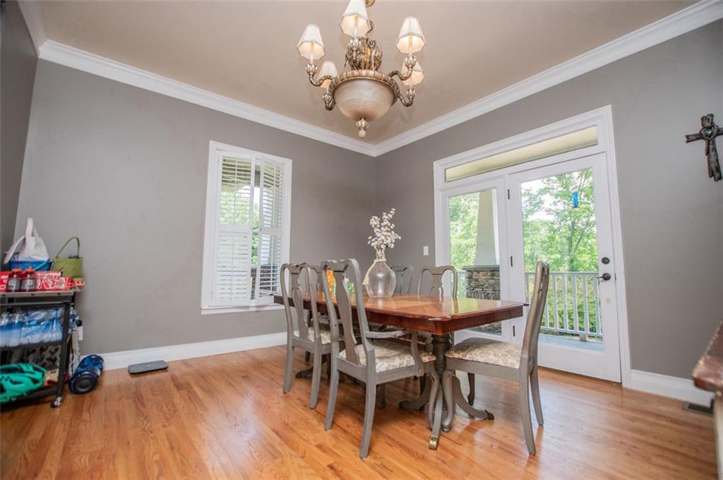6919 Mt Zion Road Waco, GA 30182 - Photo 34 of 79 a view of a dining room with furniture a chandelier and wooden floor