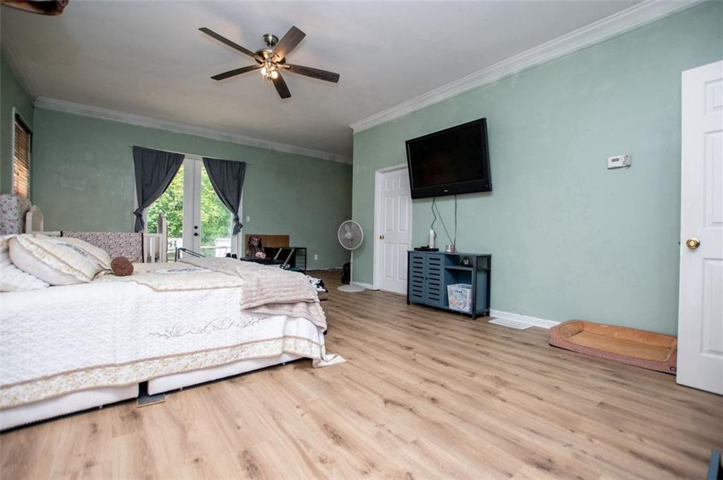 6919 Mt Zion Road Waco, GA 30182 - Photo 50 of 79 a bedroom with a bed and a flat screen tv