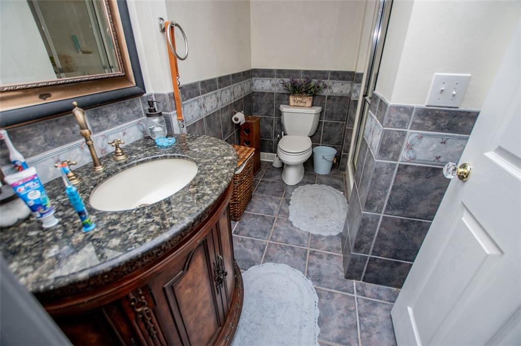 6919 Mt Zion Road Waco, GA 30182 - Photo 52 of 79 a bathroom with a toilet sink and mirror