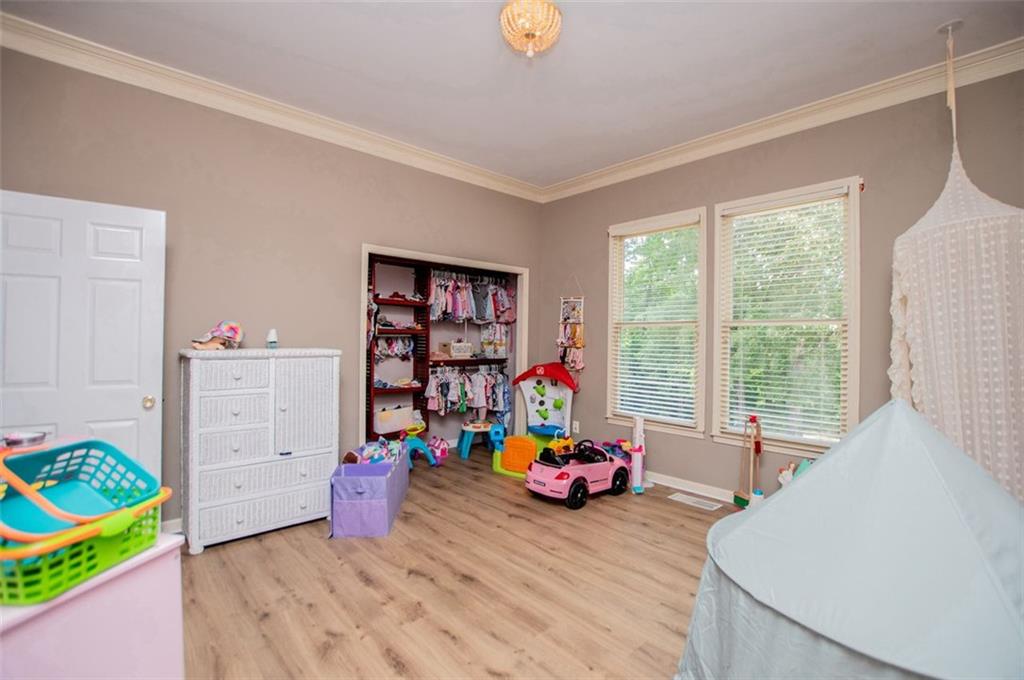 6919 Mt Zion Road Waco, GA 30182 - Photo 56 of 79 a view of a bedroom with baby crib and a window