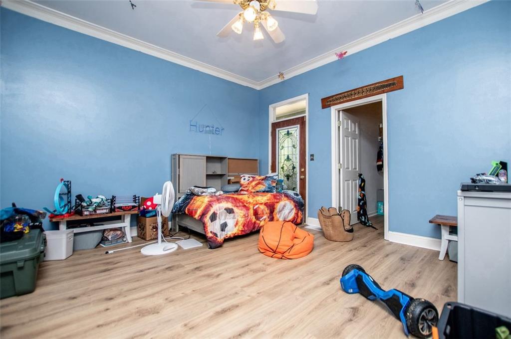 6919 Mt Zion Road Waco, GA 30182 - Photo 58 of 79 a bedroom with a bed and a chandelier