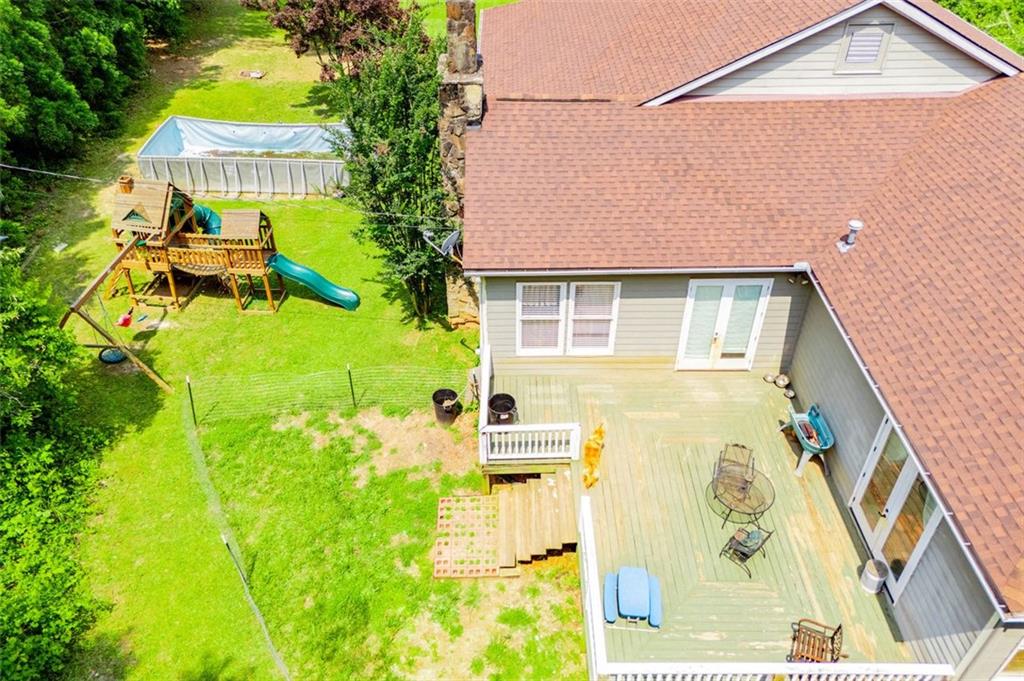 6919 Mt Zion Road Waco, GA 30182 - Photo 70 of 79 a backyard of a house with table and chairs