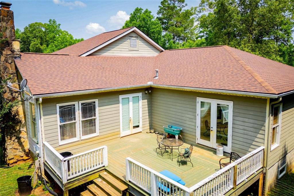 6919 Mt Zion Road Waco, GA 30182 - Photo 74 of 79 a backyard of a house with table and chairs