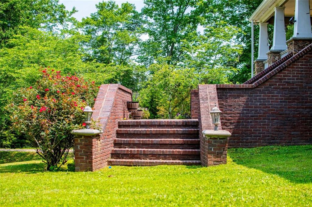 6919 Mt Zion Road Waco, GA 30182 - Photo 8 of 79 a view of a garden with a bench
