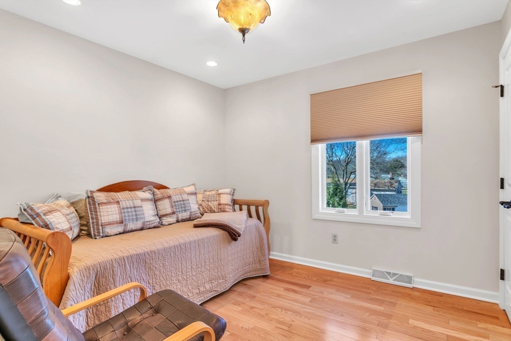 84 Willow Brook Road Longmeadow, MA 01106 - Photo 35 of 42 a bedroom with a bed and a chandelier