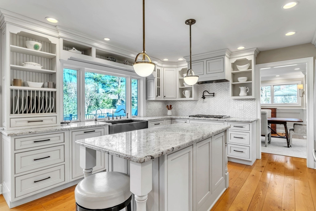 84 Willow Brook Road Longmeadow, MA 01106 - Photo 10 of 42 a kitchen with stainless steel appliances granite countertop a sink a stove and a wooden floors