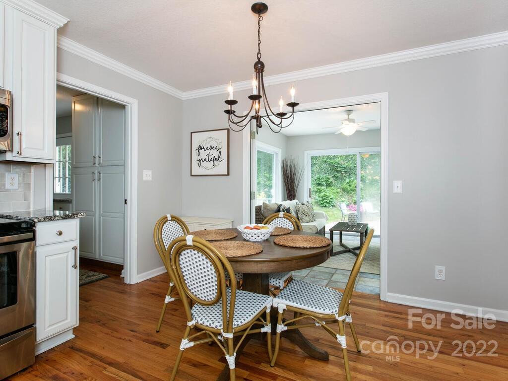 15 Devonshire Drive Candler, NC 28715 - Photo 12 of 43 a dining room with furniture a chandelier and wooden floor