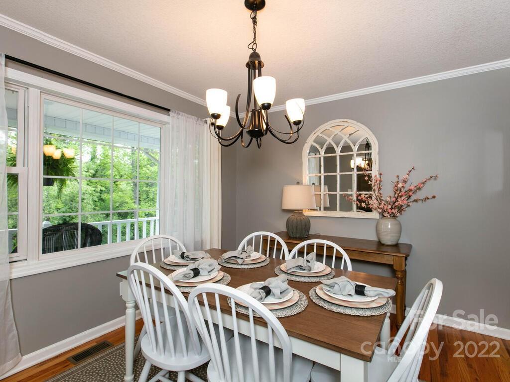 15 Devonshire Drive Candler, NC 28715 - Photo 14 of 43 a view of a dining room with furniture wooden floor and chandelier