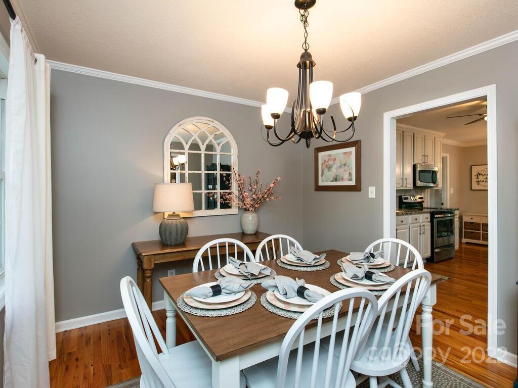 15 Devonshire Drive Candler, NC 28715 - Photo 15 of 43 a view of a dining room with furniture wooden floor and chandelier