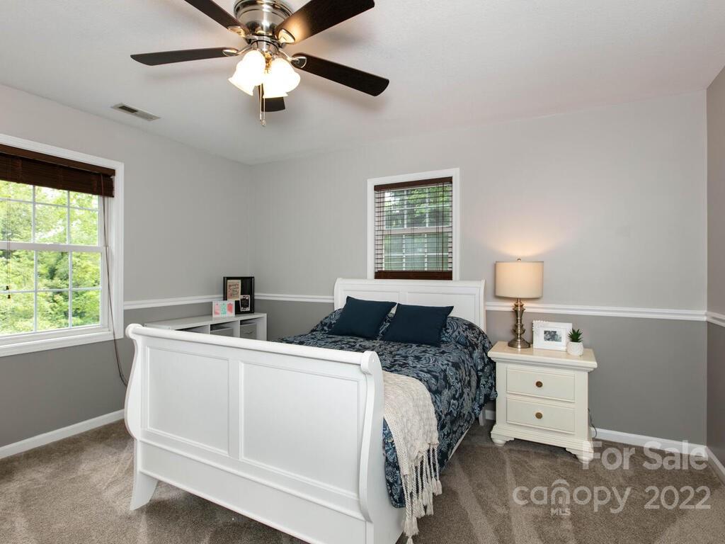 15 Devonshire Drive Candler, NC 28715 - Photo 18 of 43 a bedroom with a bed and a chandelier