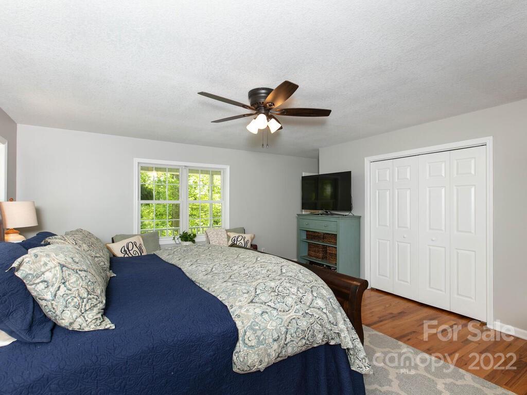 15 Devonshire Drive Candler, NC 28715 - Photo 21 of 43 a living room with a bed furniture and a flat screen tv