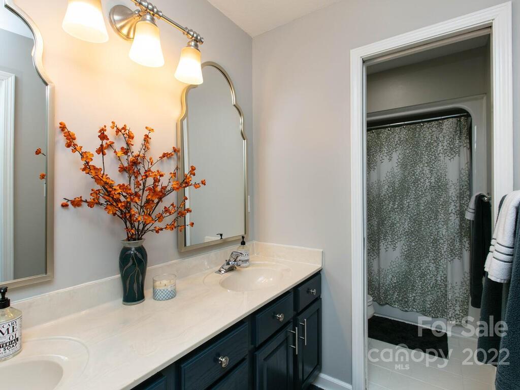 15 Devonshire Drive Candler, NC 28715 - Photo 23 of 43 a bathroom with a sink vanity granite and a mirror
