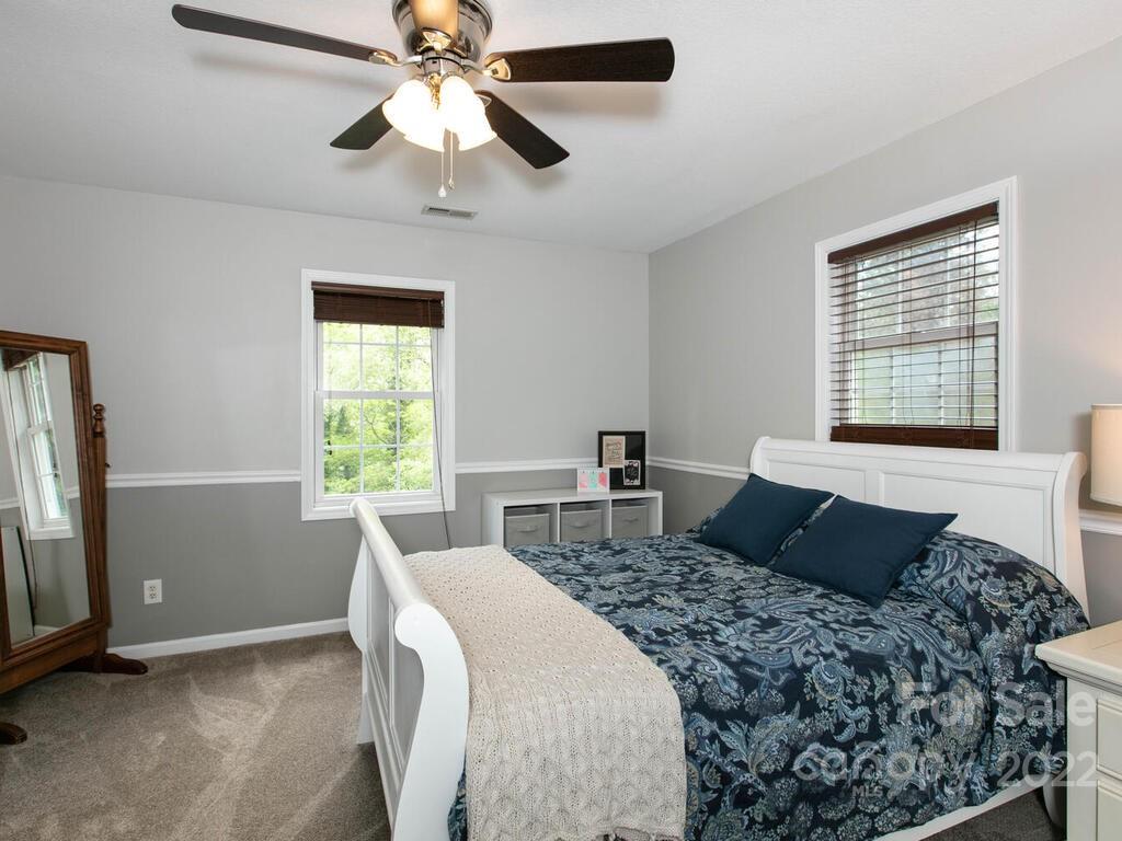 15 Devonshire Drive Candler, NC 28715 - Photo 24 of 43 a bedroom with a bed and a chandelier