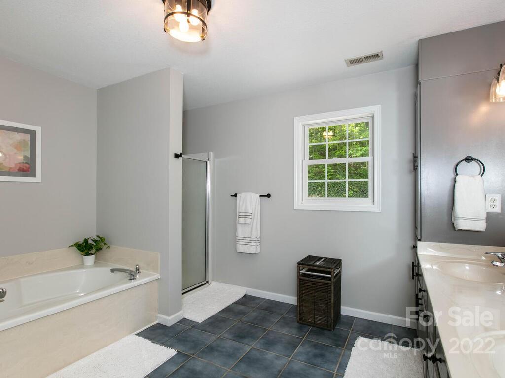 15 Devonshire Drive Candler, NC 28715 - Photo 25 of 43 a bathroom with a tub sink and window
