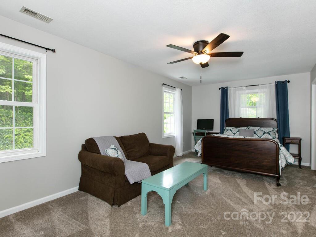 15 Devonshire Drive Candler, NC 28715 - Photo 27 of 43 a living room with furniture ceiling fan and a window